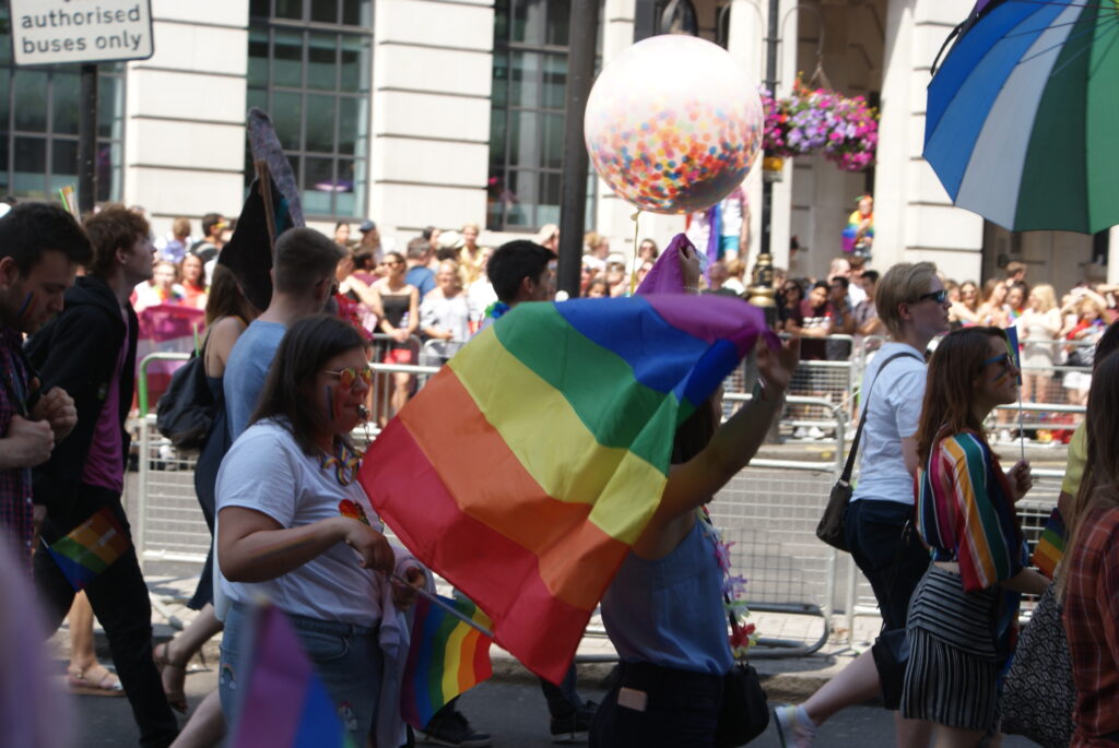 : View of the Pride flag and globe being flown in the Pride London parade
