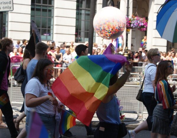 : View of the Pride flag and globe being flown in the Pride London parade