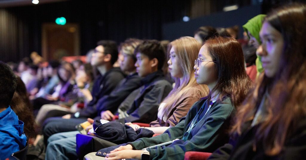A line of seated students listening intently in a lecture theatre. All Rights © Digby Oldridge/PR Eye