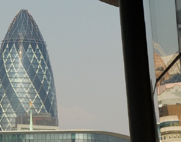 30 St Mary Axe also known as The Gherkin, sometimes referred to as The Swiss Re Tower viewed from the South side of the Thames, with City Hall in the foreground
