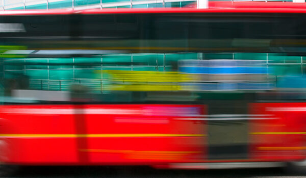 Image of a blurred red bus