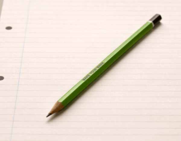 A green pencil on lined paper with