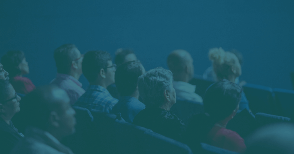 a group of people sitting in an an auditorium