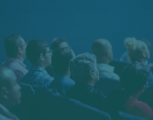 a group of people sitting in an an auditorium
