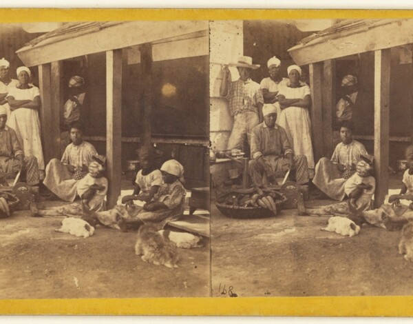 A group of enslaved Black men and women, in the kitchen of a barracoon.