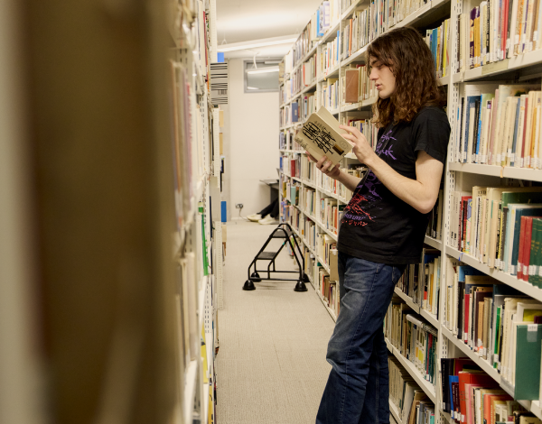 Photo of a student reading in a library